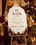 Burgundy Cream Katb Kitab welcome board displayed on an easel