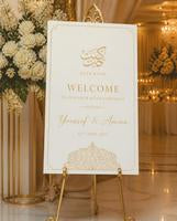 Ivory Gold Arch Katb Kitab welcome board displayed on an easel