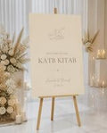 Minimal Beige Katb Kitab welcome board displayed on an easel